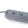Blue portable speaker, showing close-up of side ports and textured fabric finish.