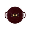 Red cast iron casserole dish with gold knob, seen from above
