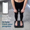 Black smart bathroom scale showing app data, used to track progress.