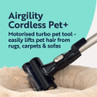 Cordless pet vacuum tool removing pet hair from fluffy rug, suitable for carpets and sofas