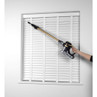 Handheld cordless vacuum cleaning white window blinds with long gold extension wand