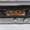 Electric grill with steak and vegetable sandwich on the cooking plate