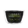 Black salad spinner with clear bowl, shown with green salad leaves inside