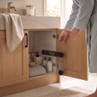 Digital bathroom scale stored in oak cabinet under sink