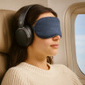 Black over-ear headphones worn by passenger on plane seat
