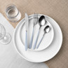 Table setting with silver cutlery and light blue handles on white plates