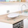 Small leaf print tabletop ironing board on kitchen counter