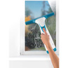 Hand using teal and white window vacuum to clean soapy glass