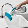 Hand emptying teal cordless window vacuum cleaner into sink