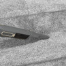 Handheld vacuum cleaning grey carpeted stairs with narrow nozzle attachment