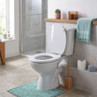 White toilet seat in bathroom setting, lid up