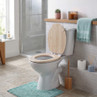 White toilet with oak-effect wooden seat in bathroom