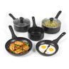Set of five black non-stick saucepans and frying pans, some shown with food