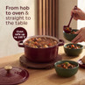 Red casserole dish filled with stew, being served into bowls; oven safe up to 240°C.