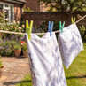 White bedding drying on a garden washing line