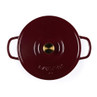 Red cast iron casserole dish with lid, top view, gold knob on handle