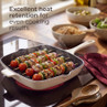 Cream grill pan with skewers of chicken, tomato and vegetables cooking on a hob