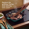 Green square grill pan on hob with steak, bacon and mushrooms cooking
