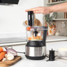 Stainless steel food processor shredding vegetables in a modern kitchen