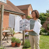 Grey peg bag with dachshund print hanging on washing line outdoors
