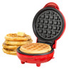 Red waffle maker open, showing cooked waffle inside with stack of waffles and butter beside