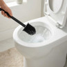 Black silicone toilet brush cleaning white toilet bowl