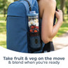 Portable blender bottle with fruit and veg in blue backpack side pocket outdoors