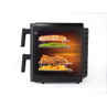Air fryer with racks cooking chicken, chips, baguette, and green beans, shown from the side