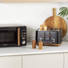 Black microwave and 4-slice toaster with wood accents on kitchen counter