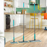 Set of three grey and turquoise flat mops in different sizes on wood floor in kitchen