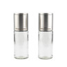 Set of two Russell Hobbs silver salt and pepper grinders with glass bodies.
