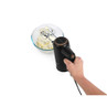 Handheld black mixer blending cream in glass bowl, showing appliance in use