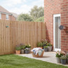 Retractable outdoor washing line installed between house wall and wooden fence