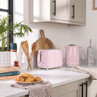 Pastel pink toaster and kettle set on kitchen counter