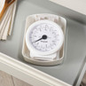 White mechanical kitchen scale with clear dial, shown stored in a drawer