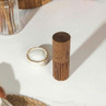 Acacia wood salt grinder on white kitchen worktop beside small bowl of salt