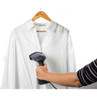 Handheld clothes steamer being used on a white shirt hanging on a wooden hanger