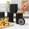 Set of three black kitchen canisters labelled coffee, tea and sugar on countertop