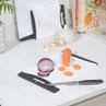 White chopping board with sliced carrot and red onion, kitchen worktop setting