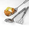 Set of three stainless steel kitchen tools, one lifting fishcake with lemon garnish.