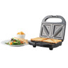 Four-slice toasted sandwich maker with toasted sandwiches, salad, and crisps on side plate