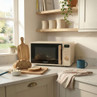 Cream microwave oven with wooden handle on kitchen counter, bread and mug beside