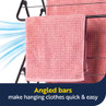 Pink waffle-textured towel hanging on angled airer bars