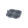 Grey silicone four-cup muffin tray, shown angled, baking accessory