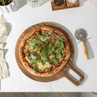 Stone-baked pizza with rocket on wooden board, overhead view