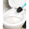 Silicone toilet brush with black bristles draining water into white toilet bowl