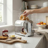 Chrome toaster on kitchen counter with bagels being toasted, suitable for product listing