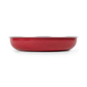 Red metal mixing bowl with silver rim, shown from the side