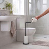 Black freestanding toilet roll holder with storage in a modern bathroom