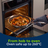 Stainless steel frying pan with roast chicken and vegetables being placed in oven, oven safe to 260°C